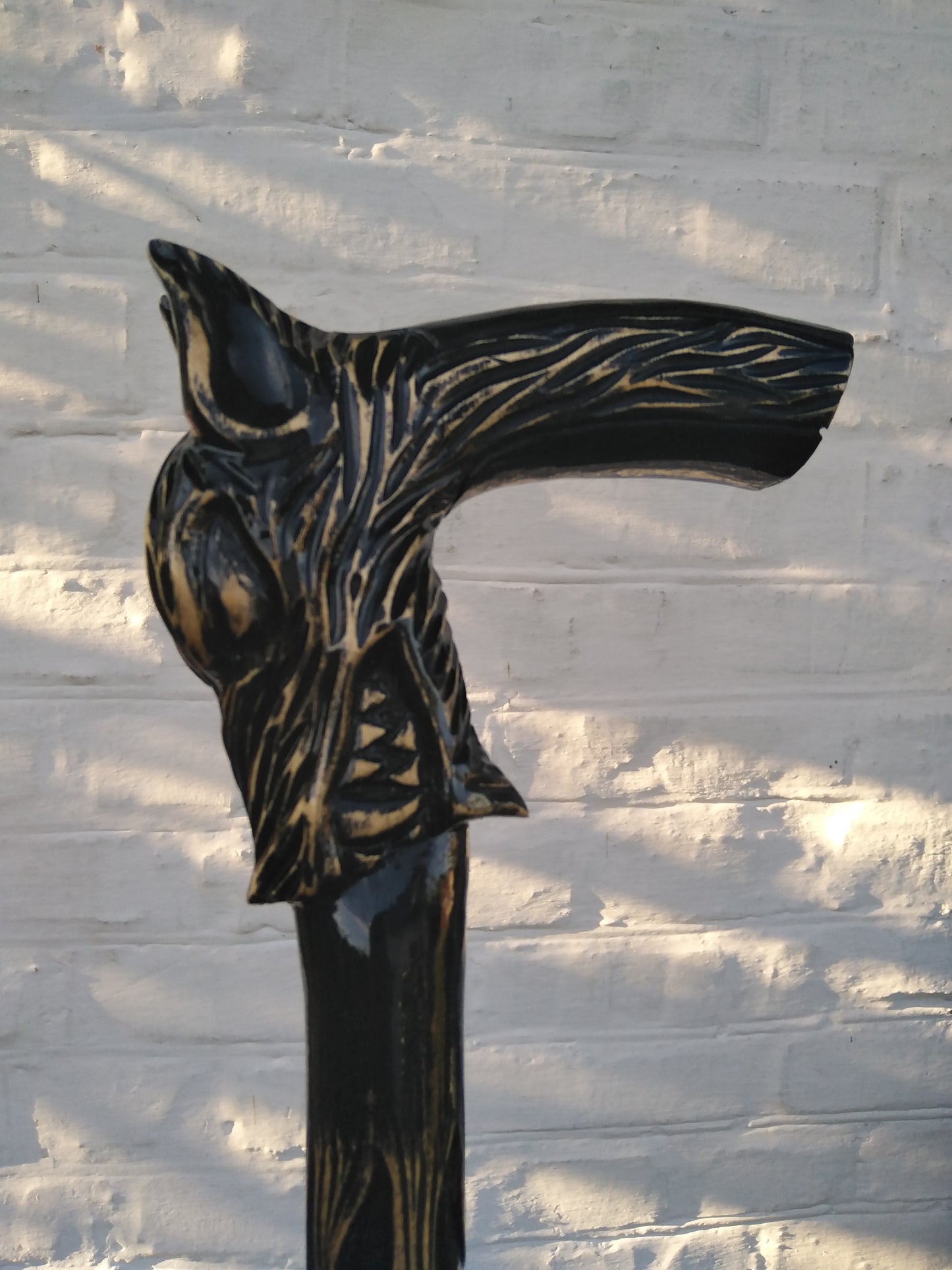 Carved wooden cane with a wolf