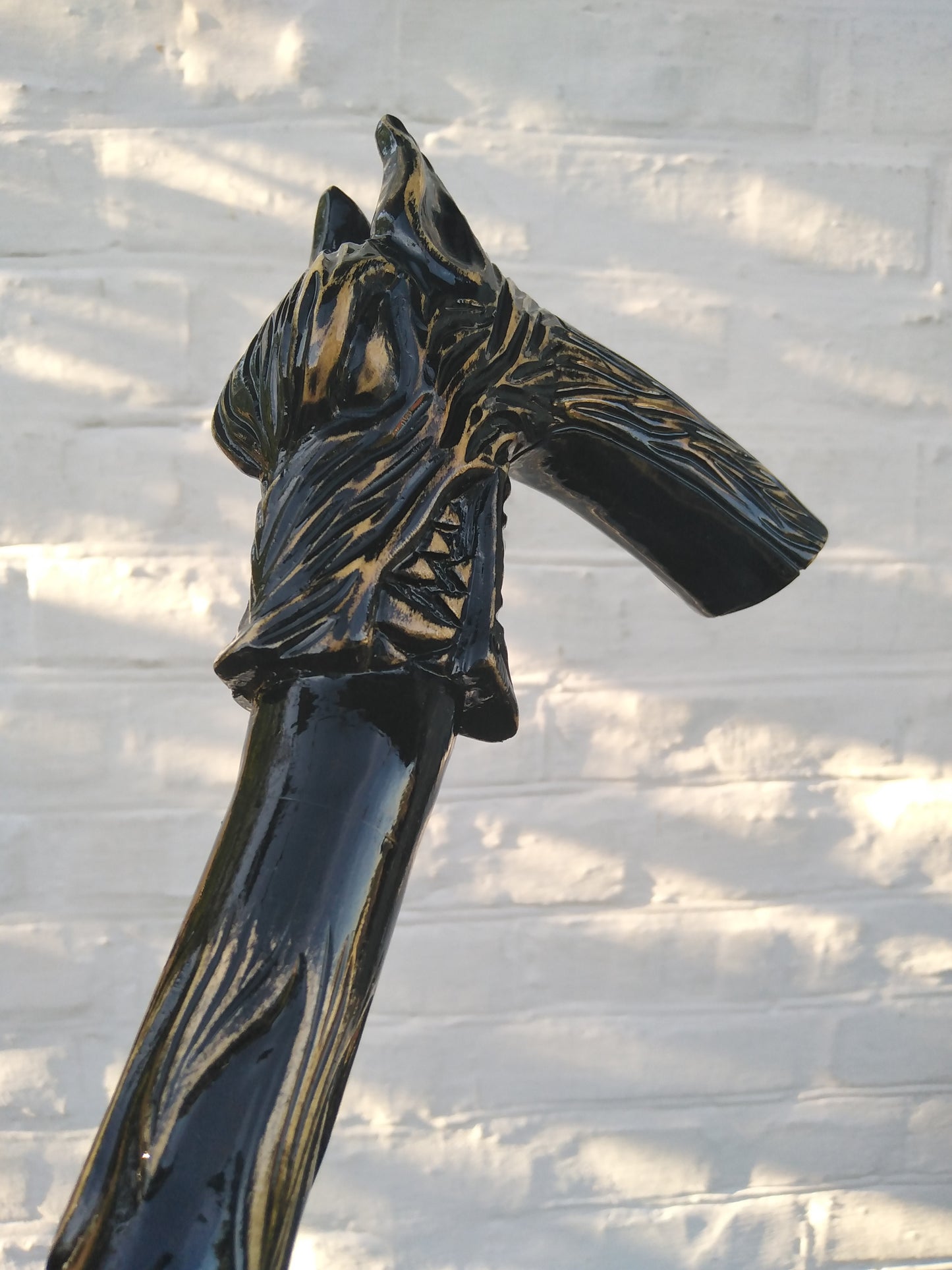 Carved wooden cane with a wolf