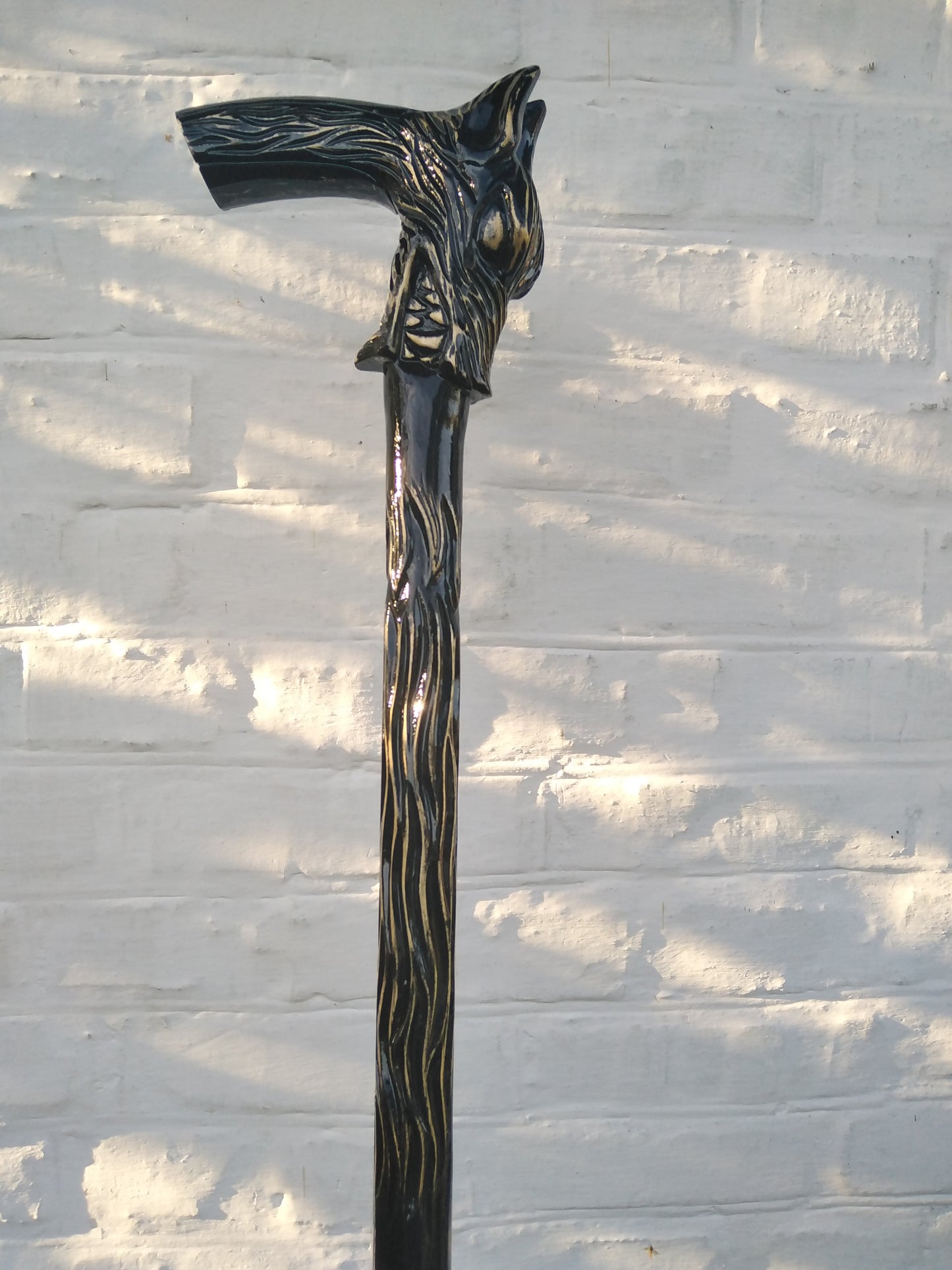 Carved wooden cane with a wolf