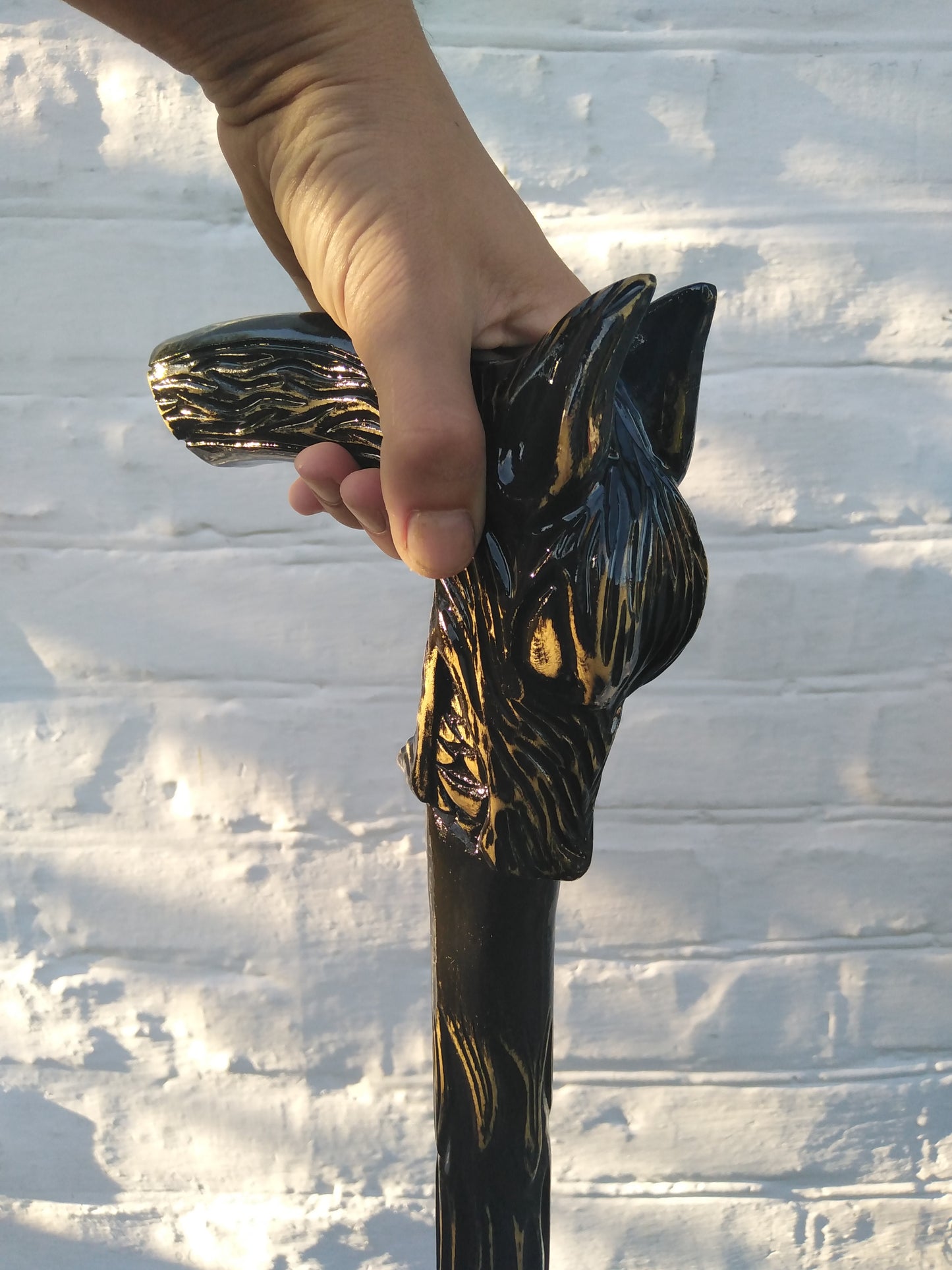 Carved wooden cane with a wolf