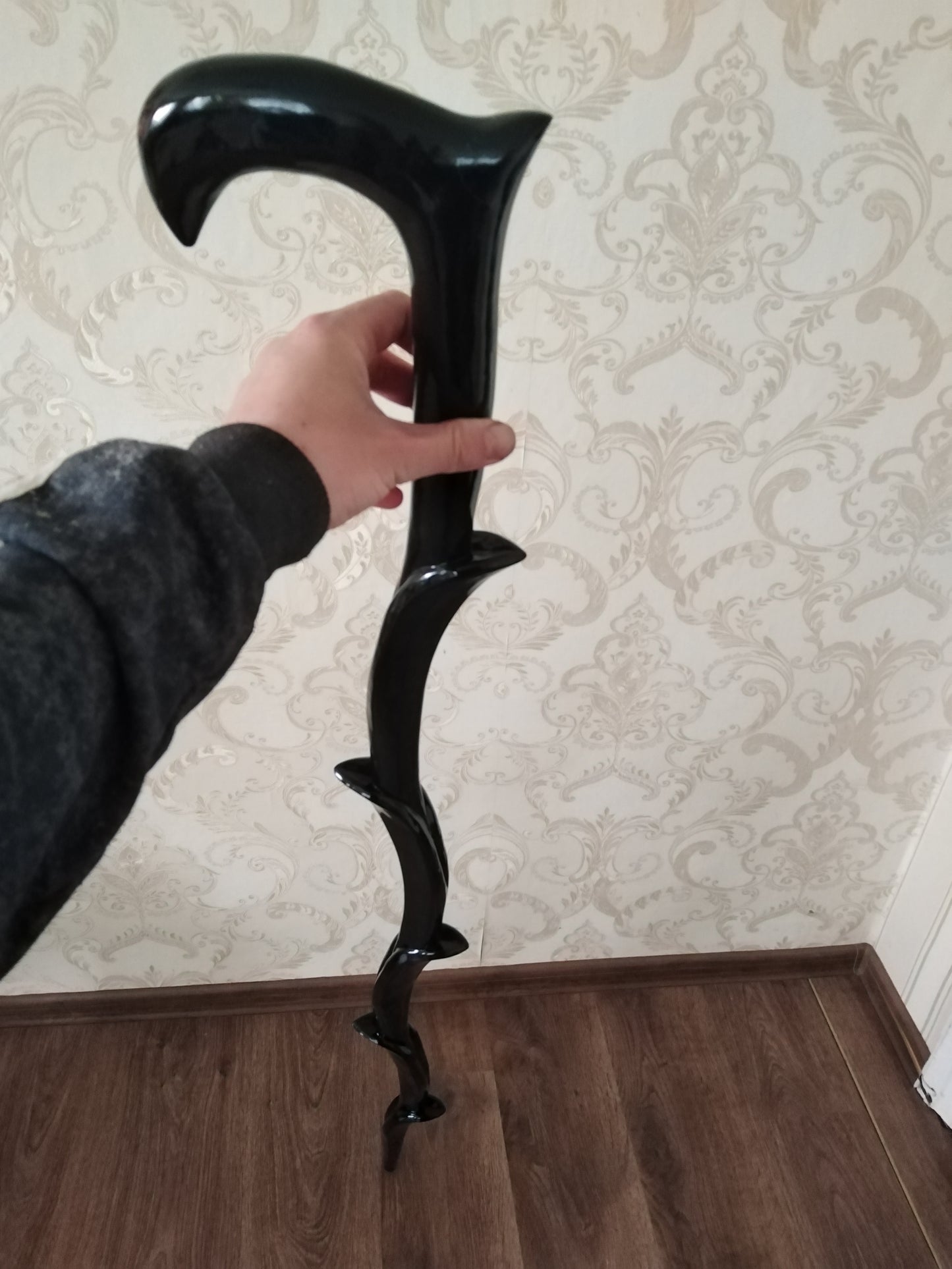 Carved wooden stick in the form of a plant