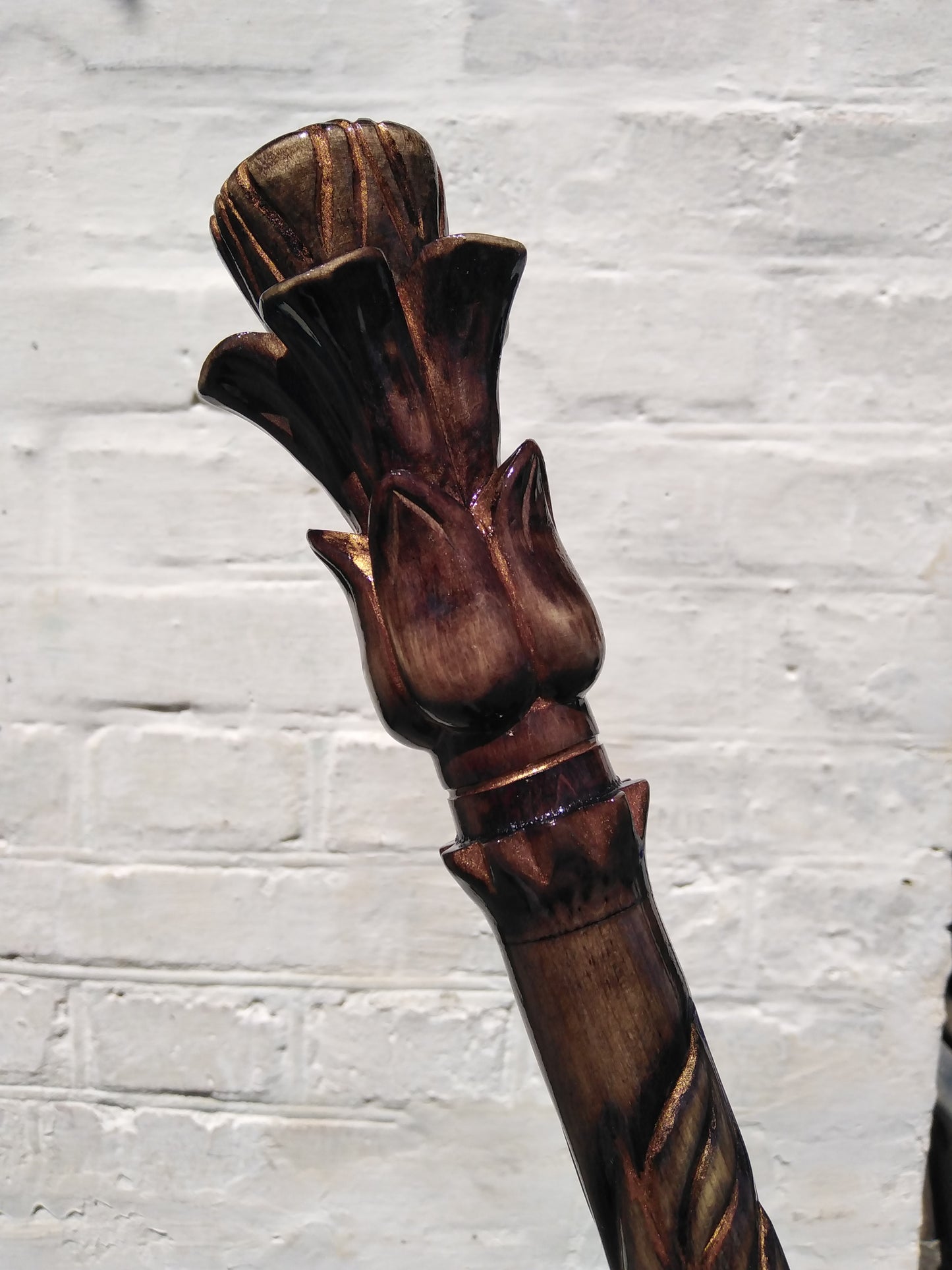 Carved wooden cane with a handle in the form of a flower