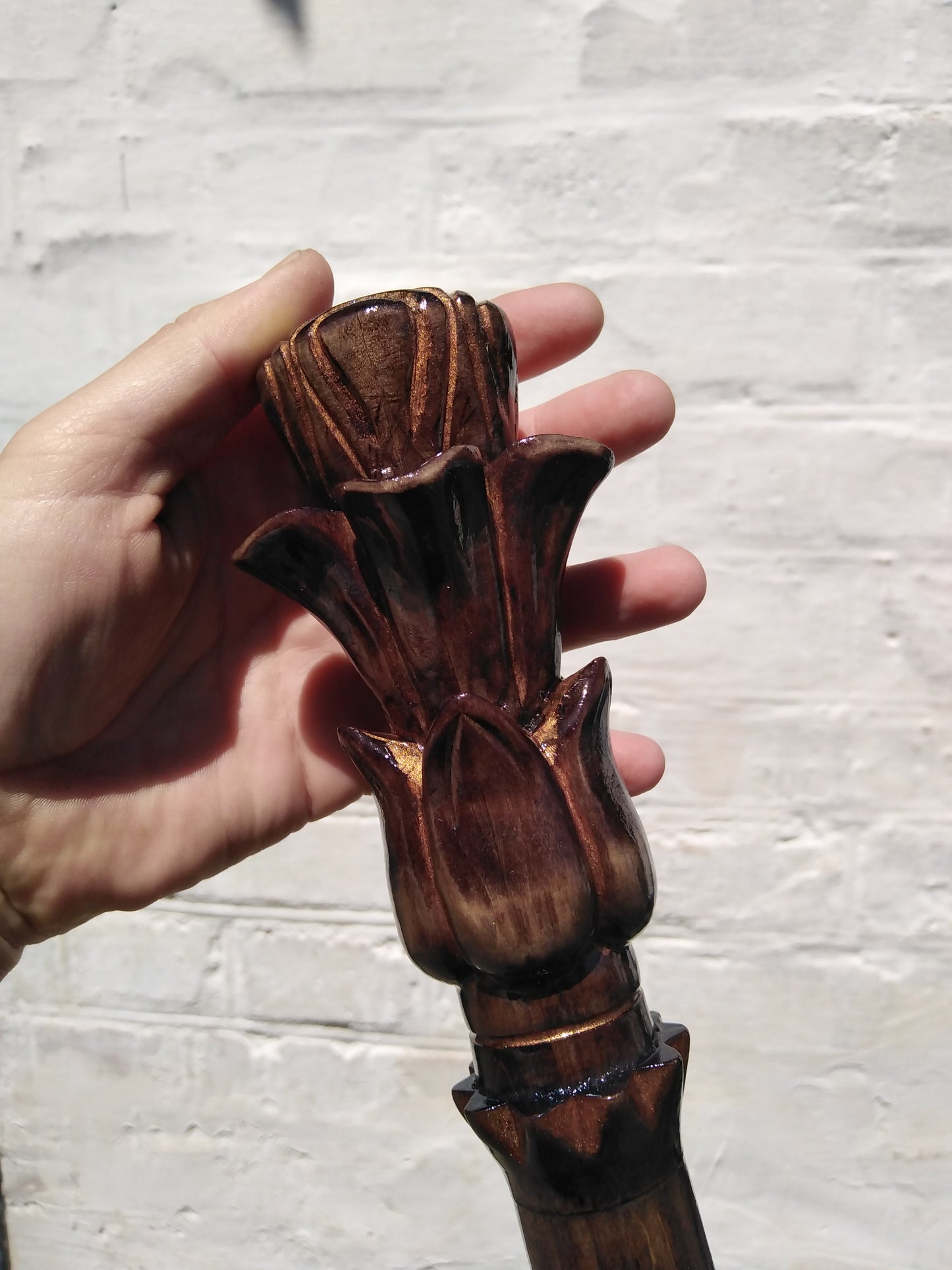 Carved wooden cane with a handle in the form of a flower