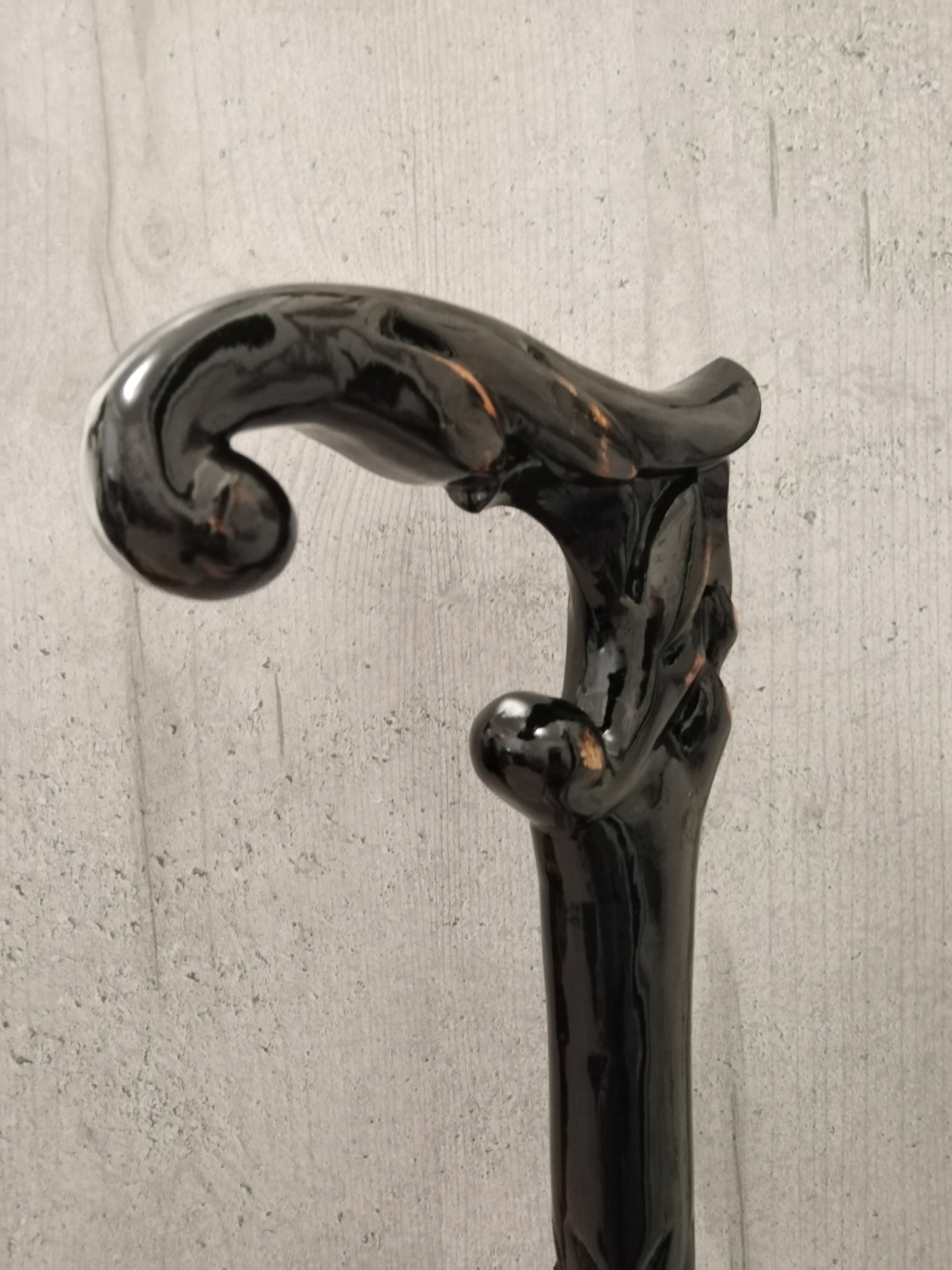 A carved wooden cane in the baroque style