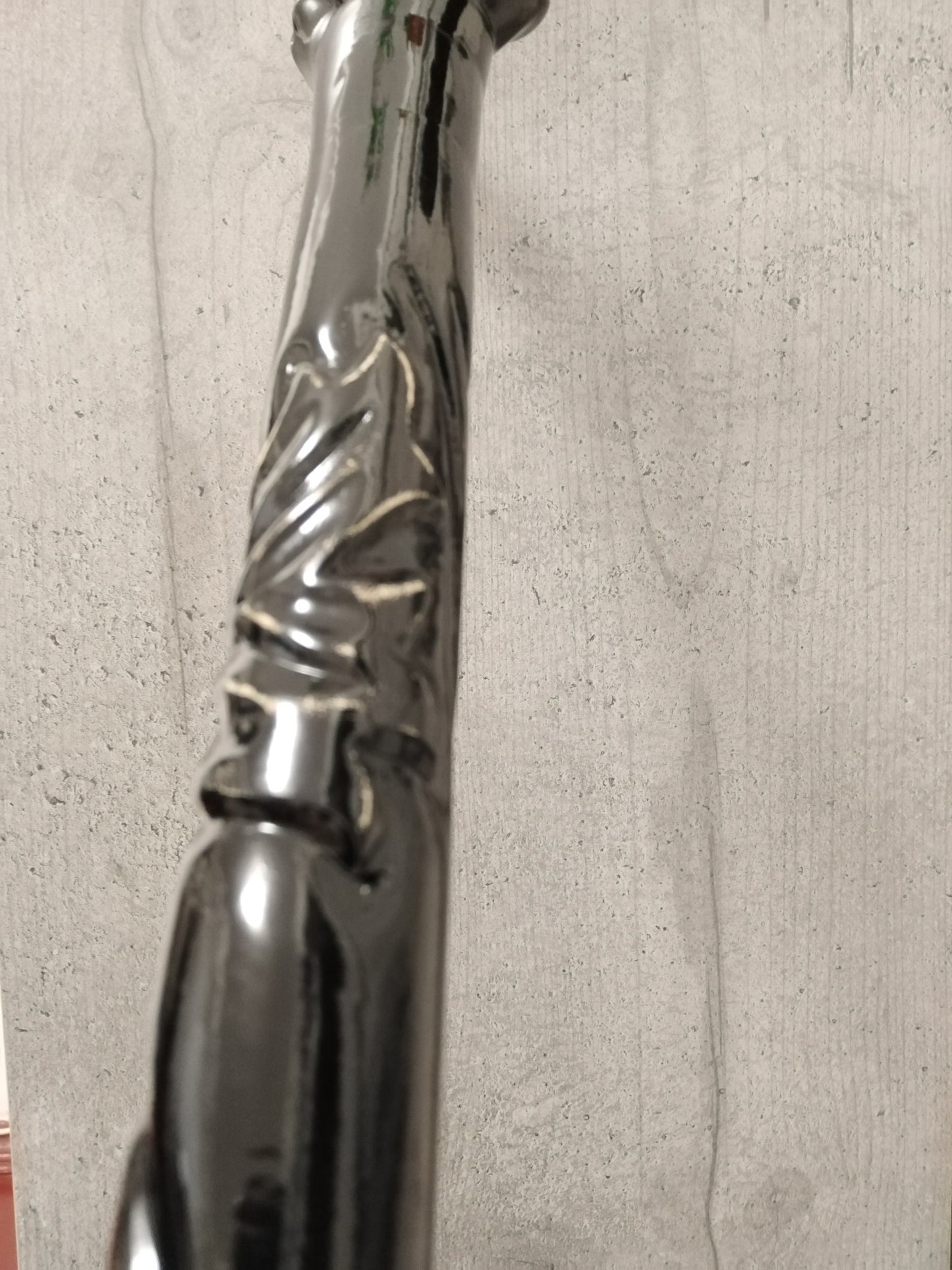 A carved wooden cane in the baroque style