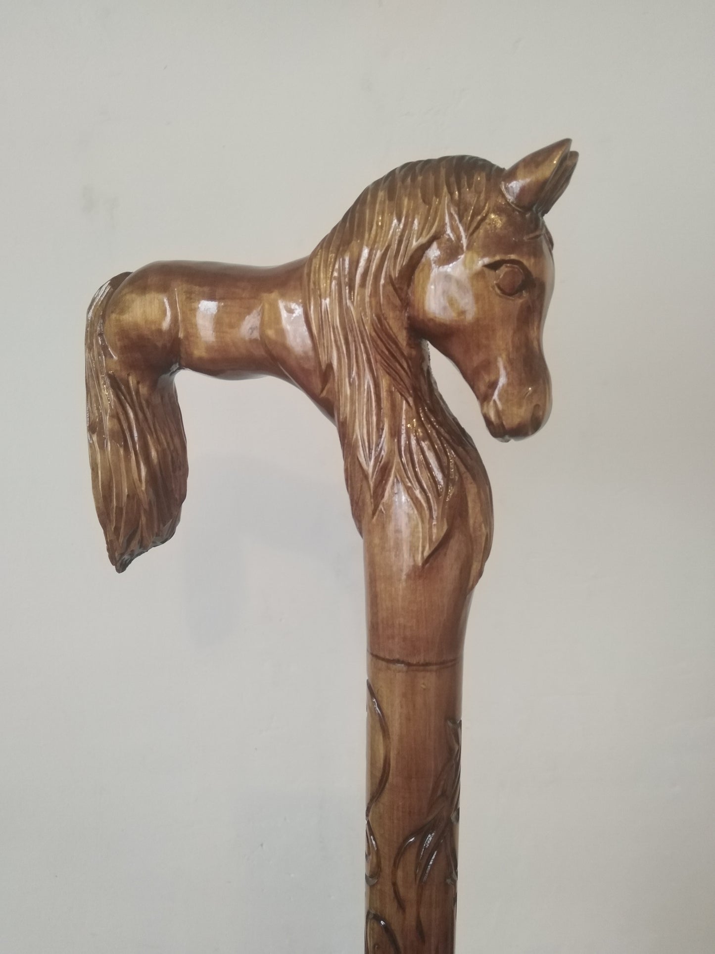 Carved wooden cane with a horse