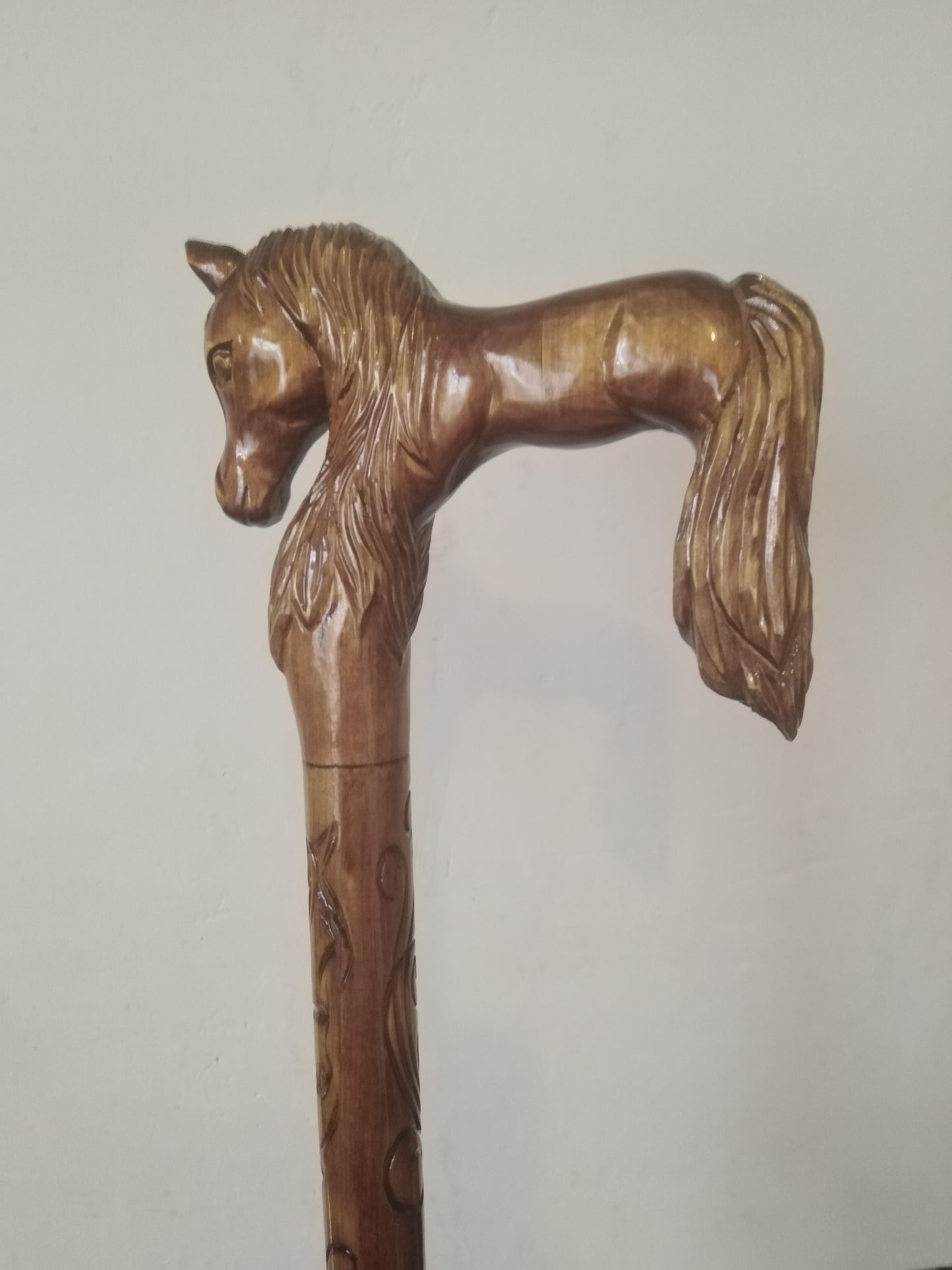 Carved wooden cane with a horse