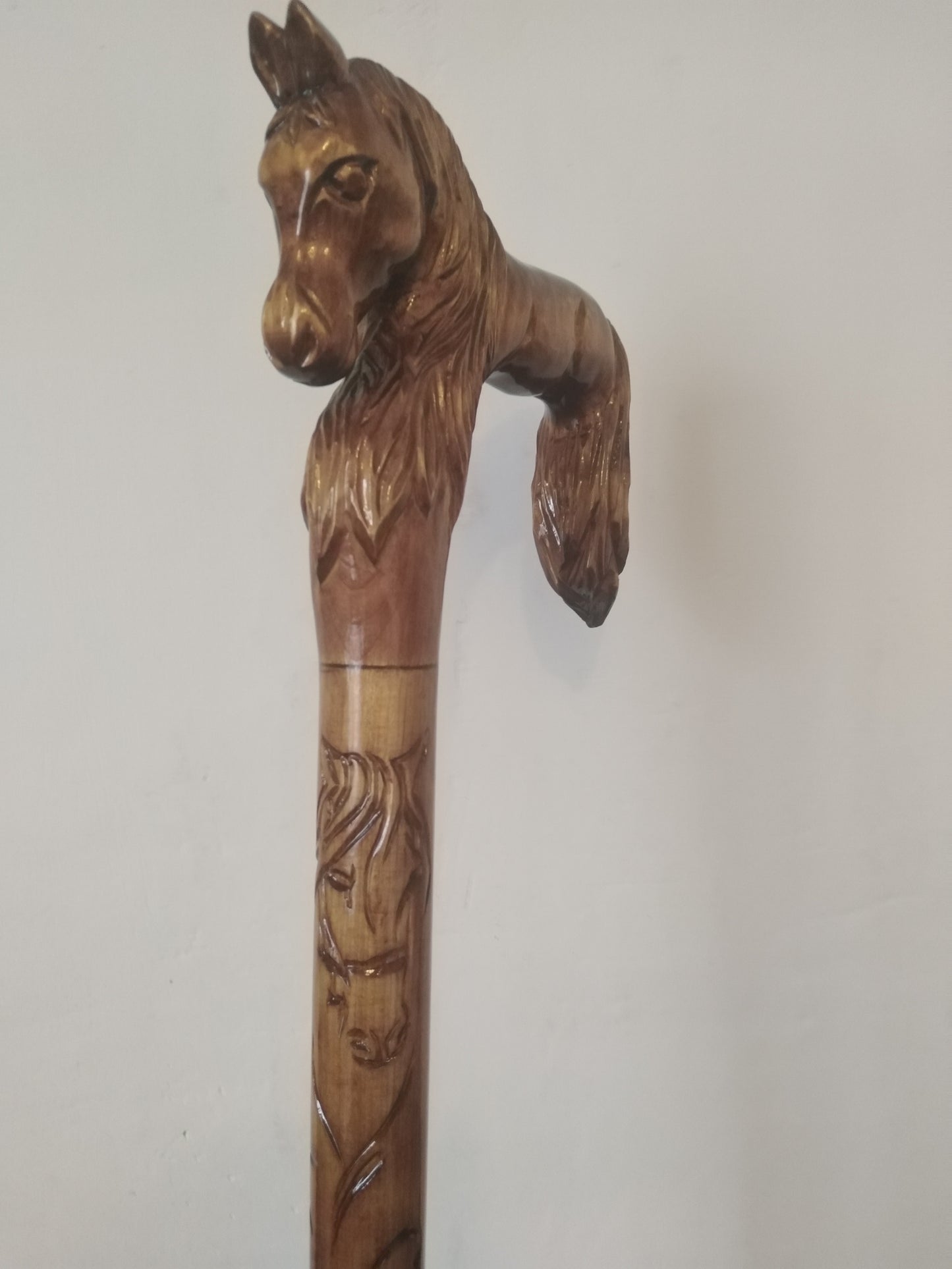 Carved wooden cane with a horse