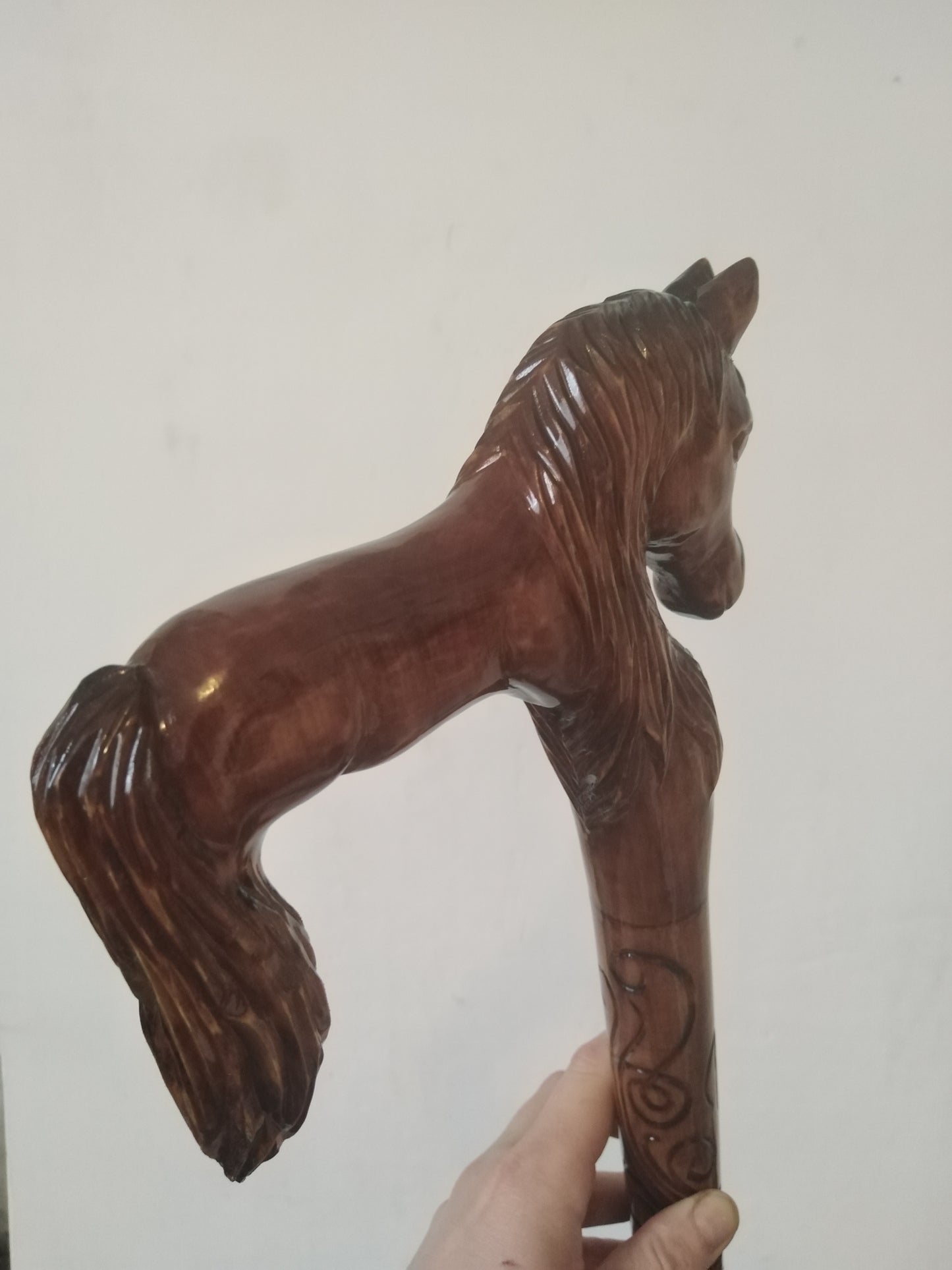 Carved wooden cane with a horse