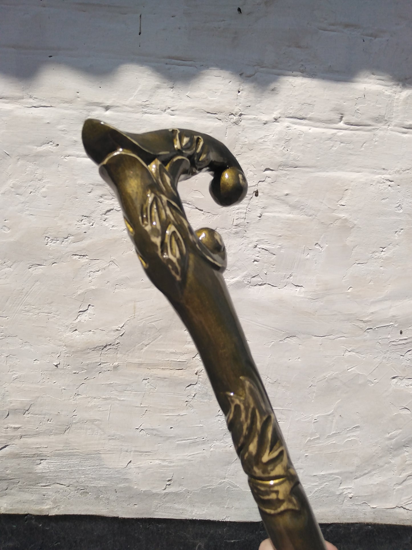 A carved wooden cane in the baroque style