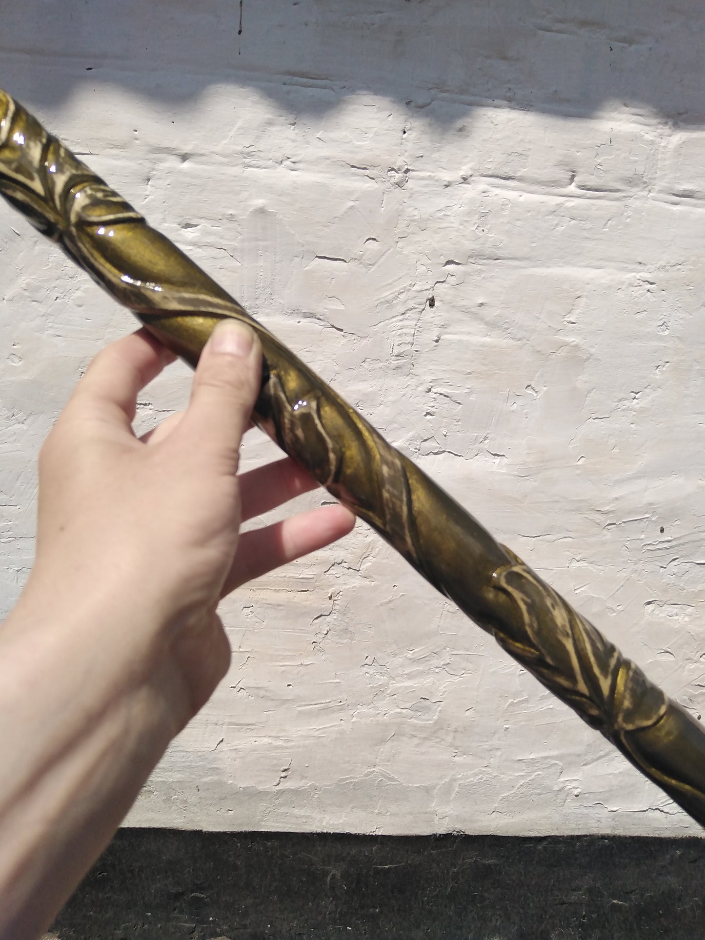 A carved wooden cane in the baroque style