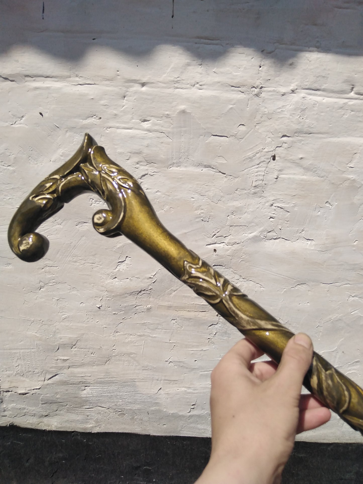 A carved wooden cane in the baroque style