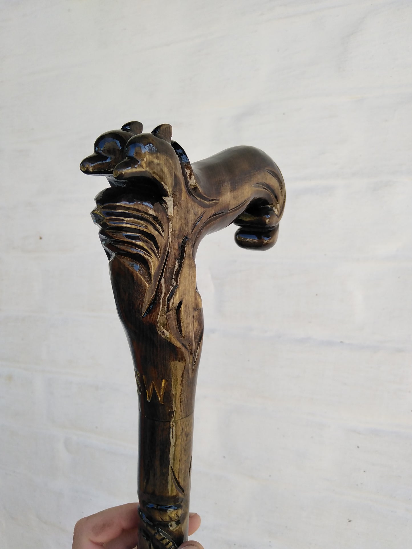 Carved wooden cane with dolphins