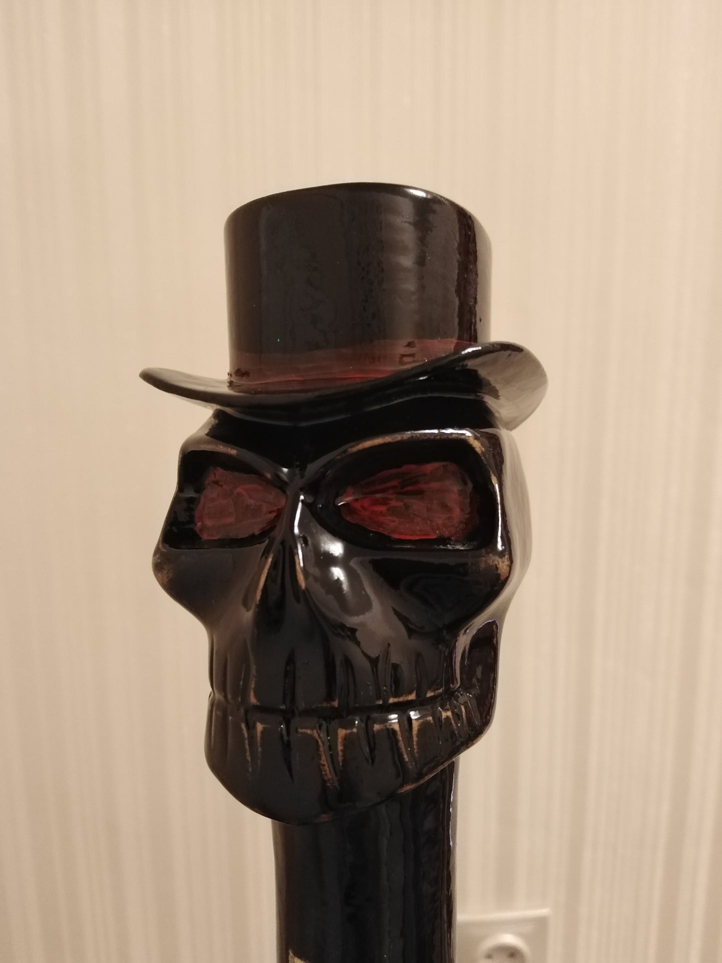 A carved wooden cane with a skull