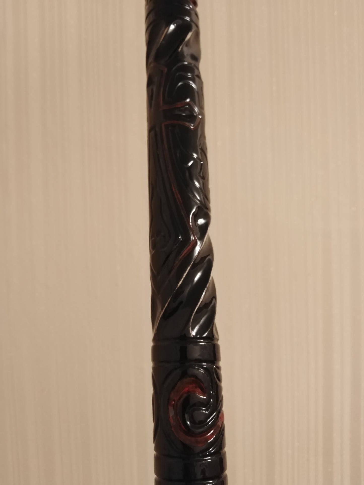 A carved wooden cane with a skull