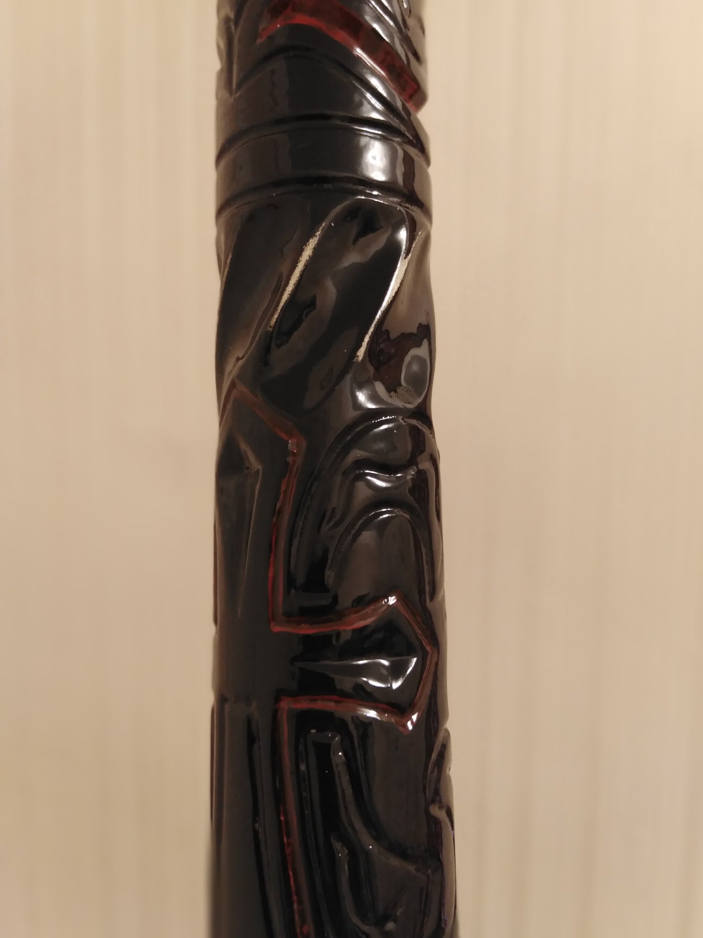 A carved wooden cane with a skull