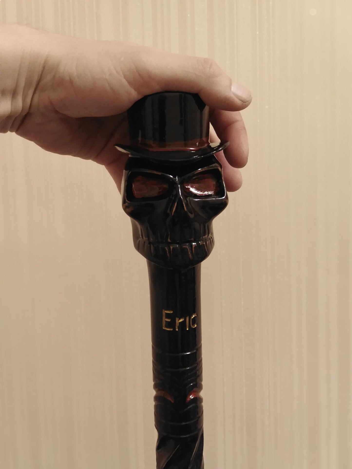 A carved wooden cane with a skull